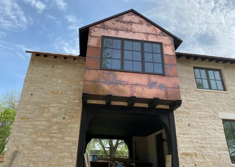 Copper metal panel facade on a stone building for Skylight Installation in Erwin